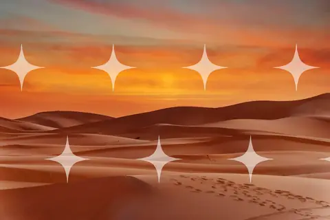 Footprints Across Dunes at Sunset